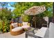 Relaxing backyard patio with seating area and umbrella at 4425 King St, Denver, CO 80211