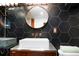 Bathroom with dark hexagonal tile, a modern sink and copper fixtures at 4425 King St, Denver, CO 80211