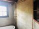 Bathroom with a clawfoot tub and exposed copper pipes at 4425 King St, Denver, CO 80211