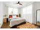 Bright bedroom with hardwood floors, a comfortable bed, and sheer curtains at 4425 King St, Denver, CO 80211