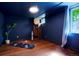 Basement exercise room with dark blue walls and hardwood floors at 4425 King St, Denver, CO 80211