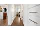 Bright hallway with hardwood floors and access to bedrooms at 4425 King St, Denver, CO 80211