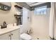Cozy bathroom featuring shower with white tiling and vintage fixtures at 2615 S Laredo Ct, Aurora, CO 80013