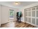 Bedroom with wood floors, closet, and window providing natural light at 2615 S Laredo Ct, Aurora, CO 80013
