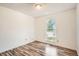 Bright bedroom featuring wood-look flooring and a window with a view of the outdoors at 2615 S Laredo Ct, Aurora, CO 80013