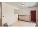 Upstairs hallway with carpet tile and view of door and railings at 2615 S Laredo Ct, Aurora, CO 80013