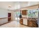 Bright kitchen with wooden cabinets, tile floors, and a sliding door with backyard access at 2615 S Laredo Ct, Aurora, CO 80013