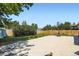 View of concrete patio with basketball hoop surrounded by greenary and wooden fence at 2615 S Laredo Ct, Aurora, CO 80013