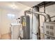 Utility room featuring a washer, dryer, and water heater at 2615 S Laredo Ct, Aurora, CO 80013