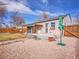 Charming backyard featuring a deck, a quaint patio, and gravel landscaping for easy maintenance at 1681 Nome St, Aurora, CO 80010