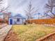 This backyard offers a shed, swing set, and mixed gravel/grass groundcover, perfect for outdoor activities at 1681 Nome St, Aurora, CO 80010