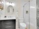 Modern bathroom featuring glass enclosed shower, vanity with black cabinets, white countertop and backsplash tile at 1681 Nome St, Aurora, CO 80010