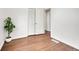 Bedroom with hardwood floors, view of closet, plant in white pot at 1681 Nome St, Aurora, CO 80010