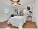 Bright bedroom with white walls, wood floor, ceiling fan, and natural light from two windows at 1681 Nome St, Aurora, CO 80010