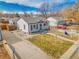 Charming home featuring mature landscaping, a welcoming front yard, and an inviting entryway at 1681 Nome St, Aurora, CO 80010