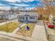 Charming house with a well-maintained lawn, mature tree, and an inviting walkway leading to the front door at 1681 Nome St, Aurora, CO 80010