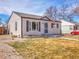 Well-maintained single-story home featuring classic architecture and a lovely front yard on a bright day at 1681 Nome St, Aurora, CO 80010