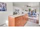 Open living space with an island kitchen area, front door, large windows, and hardwood flooring at 1681 Nome St, Aurora, CO 80010