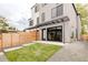 Backyard featuring a well-maintained lawn, modern patio, and tasteful wooden fence at 4322 Quivas St, Denver, CO 80211