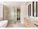 Spa-like bathroom with modern soaking tub, glass enclosed shower, and double vanity with sleek fixtures at 4322 Quivas St, Denver, CO 80211