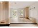 Bright entryway with modern light fixture, built-in bench, closet, and sleek wood floors at 4322 Quivas St, Denver, CO 80211