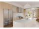 Bright, modern kitchen featuring stainless steel appliances, island sink, and light wood cabinets at 4322 Quivas St, Denver, CO 80211
