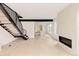 Open-concept living area with modern fireplace, staircase, and view of the bright kitchen at 4322 Quivas St, Denver, CO 80211