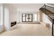 Open living space with fireplace, modern staircase, and light wood floors with seamless indoor/outdoor flow at 4322 Quivas St, Denver, CO 80211