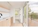 Charming wet bar area with modern fixtures and ample counter space, leading to a scenic balcony at 4322 Quivas St, Denver, CO 80211