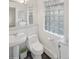 Cozy half bathroom with white fixtures and tile accents at 38 Hillside Dr, Wheat Ridge, CO 80215