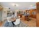 Open dining room and kitchen with modern light fixtures, stainless appliances, and hardwood floors at 38 Hillside Dr, Wheat Ridge, CO 80215