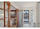 Inviting entryway with decorative glass sidelights and tile flooring leads into a wood-paneled office at 38 Hillside Dr, Wheat Ridge, CO 80215