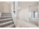 Hallway with carpeted stairs, white trim, and neutral walls at 11103 E Alameda Ave # 102, Aurora, CO 80012