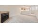 Open concept living room featuring a fireplace and easy access to the kitchen at 11103 E Alameda Ave # 102, Aurora, CO 80012