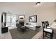 Inviting living room featuring a cozy fireplace, neutral tones, and sliding door access to the outside at 11103 E Alameda Ave # 102, Aurora, CO 80012