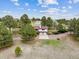 Sprawling property featuring a two-story home with a two car garage and surrounding mature trees at 11035 E Parker Rd, Parker, CO 80138