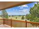 Back porch area with wooden railing offering scenic views of the landscape at 11035 E Parker Rd, Parker, CO 80138