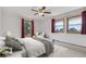 Serene bedroom with natural light from two windows and comfortable furnishings at 11035 E Parker Rd, Parker, CO 80138