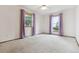Bedroom features neutral carpet and large windows at 11035 E Parker Rd, Parker, CO 80138