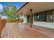 Spacious wooden deck featuring multiple support beams and railings with tree views at 11035 E Parker Rd, Parker, CO 80138