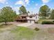 Charming two-story home with a large deck and two car garage in a lush, green setting at 11035 E Parker Rd, Parker, CO 80138