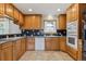 Spacious kitchen features light cabinetry, tiled backsplash, built in appliances and tiled flooring at 11035 E Parker Rd, Parker, CO 80138