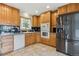 Spacious kitchen features light cabinetry, tiled backsplash, stainless refrigerator, and tiled flooring at 11035 E Parker Rd, Parker, CO 80138