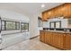Kitchen with oak cabinetry, tiled countertops, and adjoins a light filled dining room at 11035 E Parker Rd, Parker, CO 80138