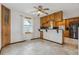 Eat-in kitchen with tile floors, wood cabinets, and stainless steel appliances at 11035 E Parker Rd, Parker, CO 80138