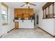 Eat-in kitchen features light cabinetry, tiled floors, stainless refrigerator, and breakfast bar at 11035 E Parker Rd, Parker, CO 80138