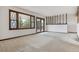 Bright living room with large windows leading to a deck, and carpet floors at 11035 E Parker Rd, Parker, CO 80138