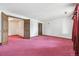 Neutral room offering neutral color scheme, open doorway, and pink carpet at 11035 E Parker Rd, Parker, CO 80138