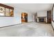 Open concept living room featuring a stone fireplace and seamless flow into the adjacent kitchen area at 11035 E Parker Rd, Parker, CO 80138