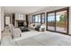 Inviting living room featuring a stone fireplace, sliding glass doors to a deck, and stylish decor at 11035 E Parker Rd, Parker, CO 80138